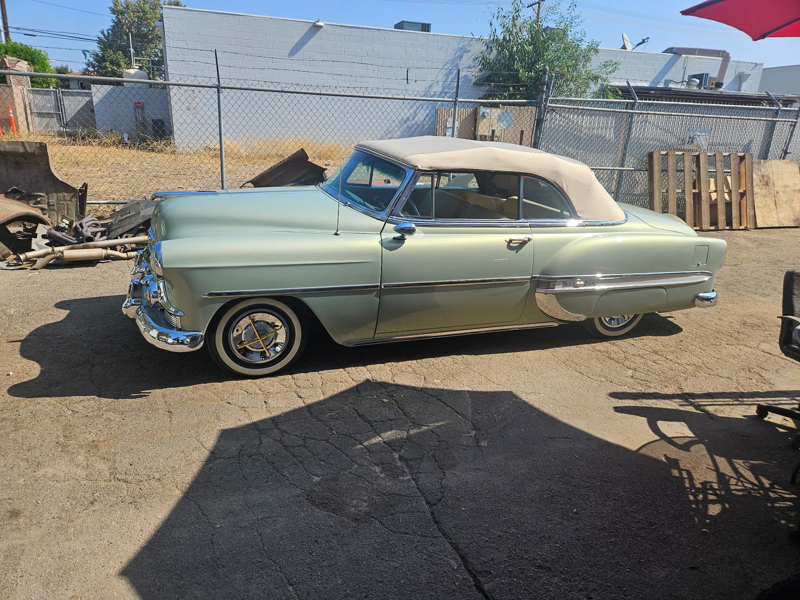 Restored Bel Air convertible in sage green metallic with tan top, side profile