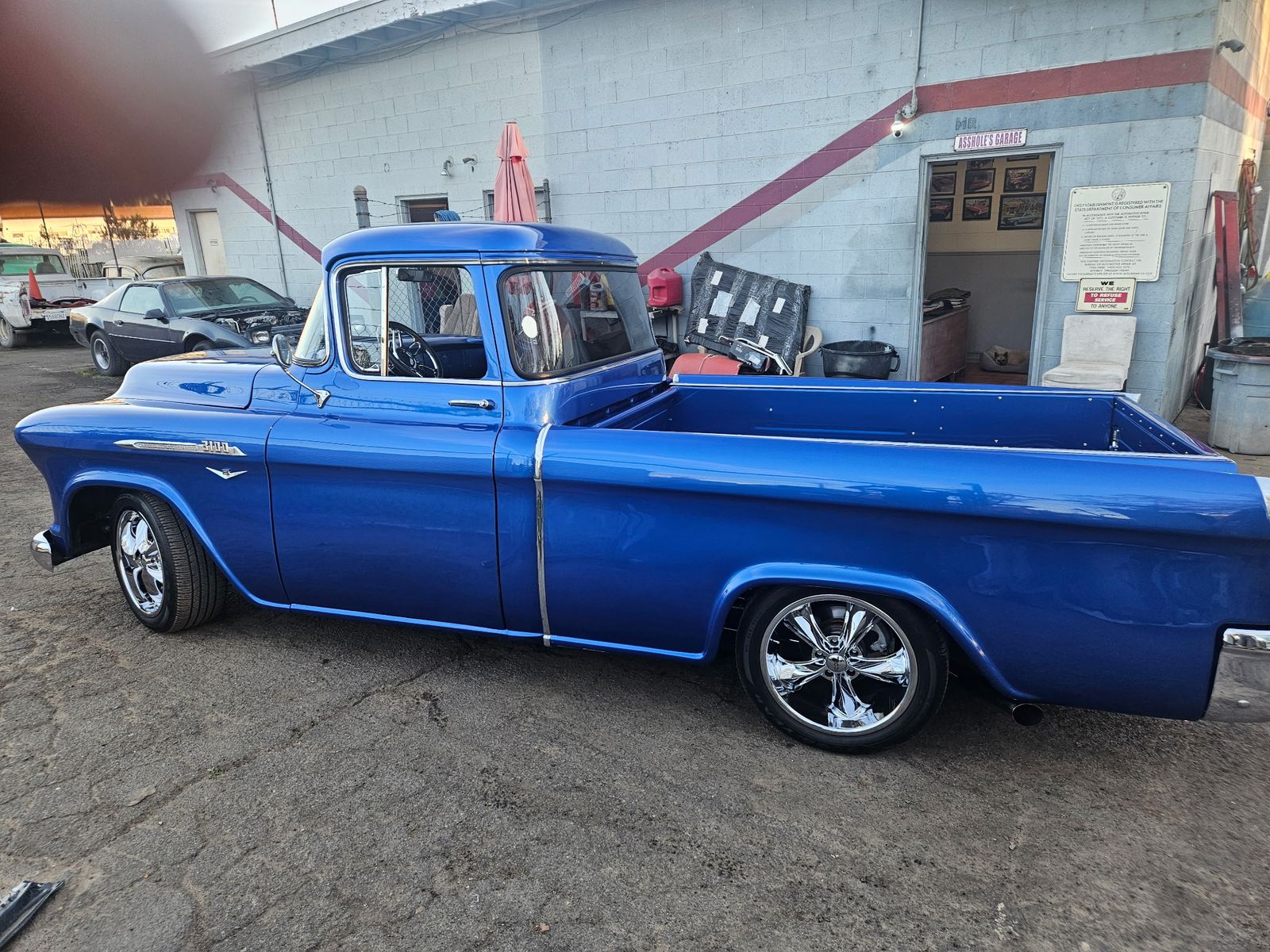 1956 Chevrolet 3100 — Profile at the shop door.
