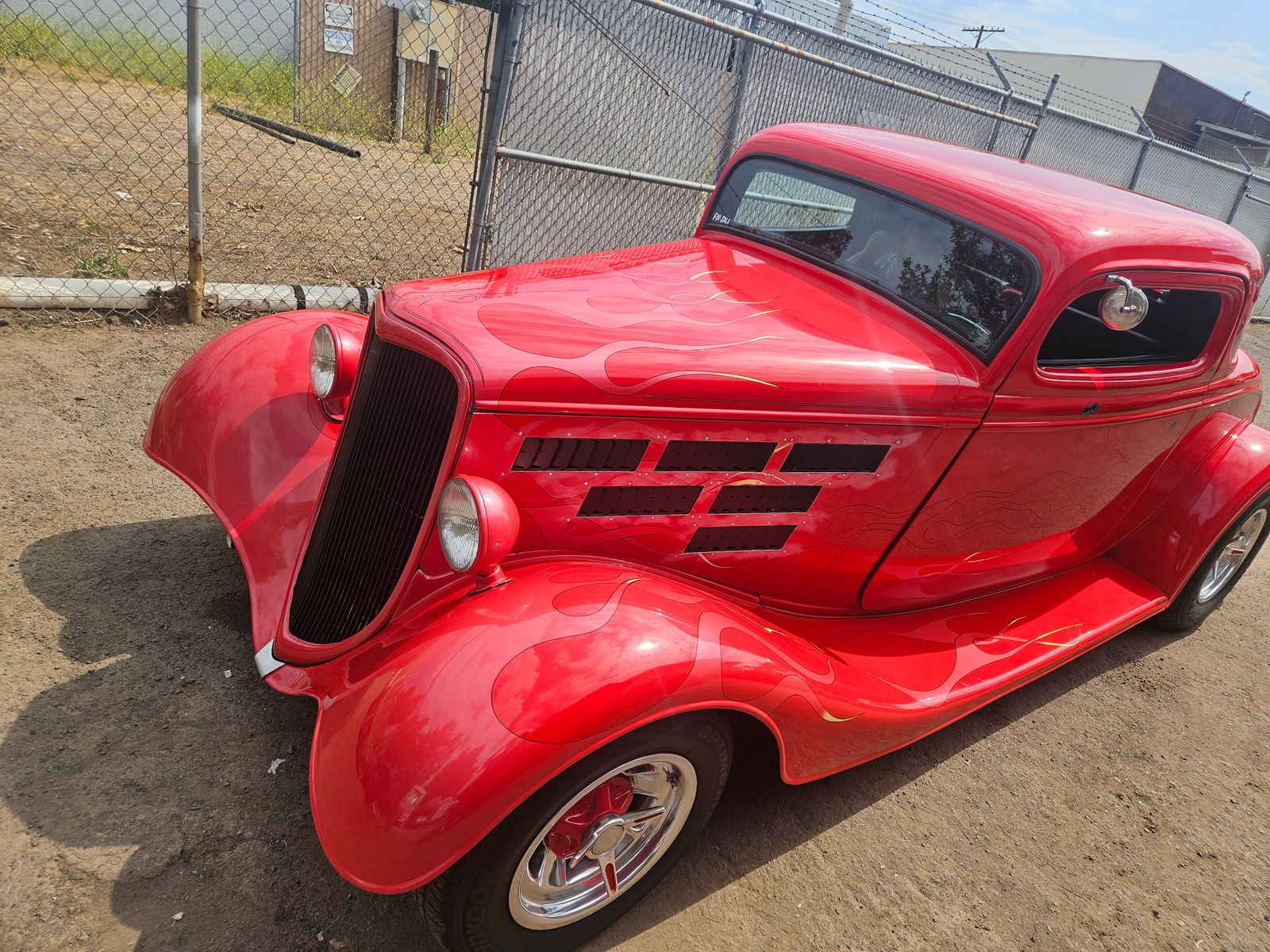 1934 Ford Three-Window Coupe — Front three-quarter — flame layout across the nose.